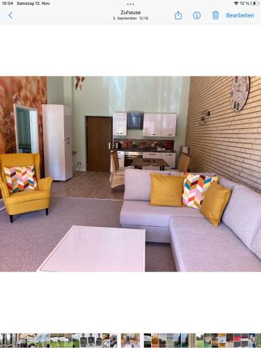a living room with a couch and two chairs at Ferienwohnung Holtz 7 in Mesekenhagen