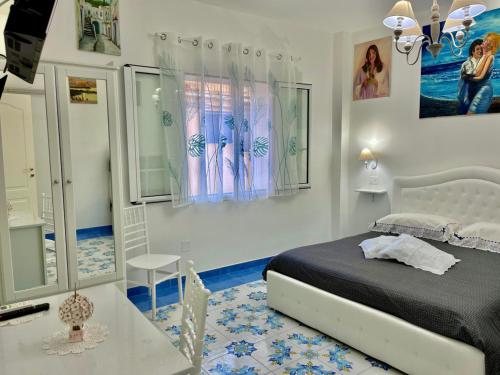 a bedroom with a bed and a table in it at Il borgo di Iaconti in Vietri sul Mare