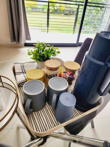 a table with a rack with four drums on it at Eastern Road Executive Suites in Harare