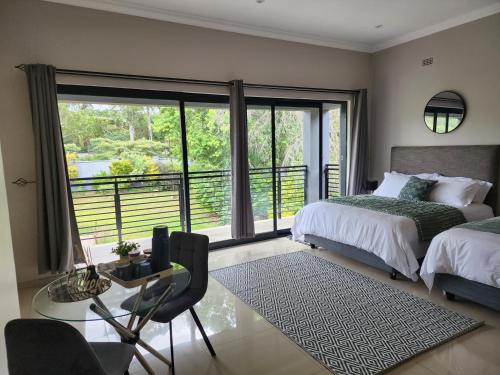 a bedroom with a bed and a large window at Eastern Road Executive Suites in Harare