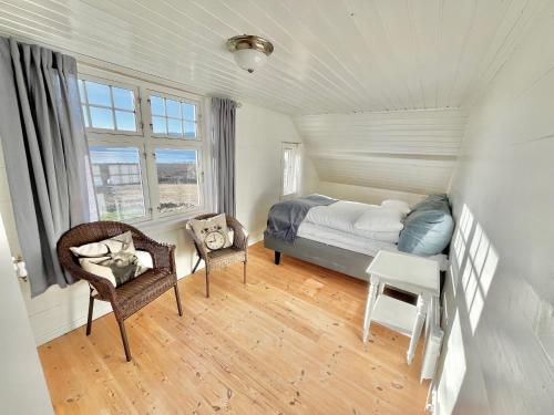 a bedroom with a bed and a desk and a chair at Oanes House in Strand