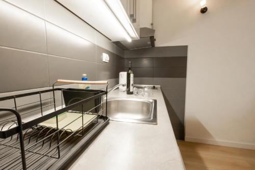 a kitchen with a stainless steel sink and a counter at Apartments Kržanić in Podgora