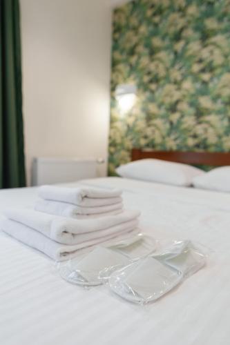 a pile of towels sitting on top of a bed at BonApart Delux in Lviv