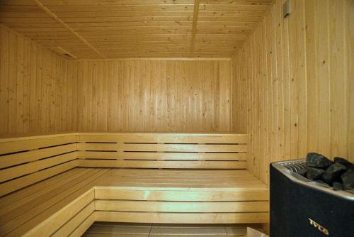 a wooden sauna with a bench in the middle at Prestige 403 1 BED in Paphos