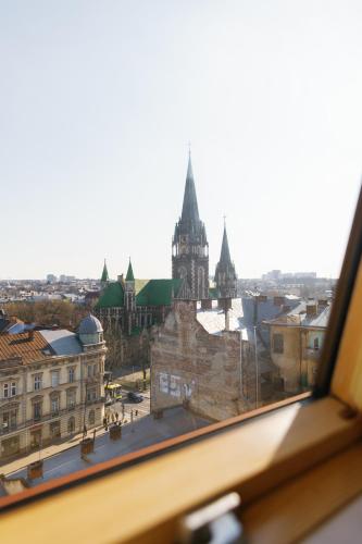 a view of a city from a window at BonApart Delux in Lviv