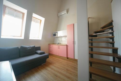 a living room with a couch and a kitchen at BonApart Delux in Lviv