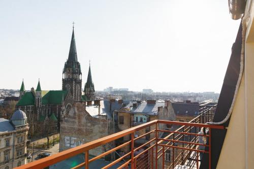 a view of the city from a balcony at BonApart Delux in Lviv