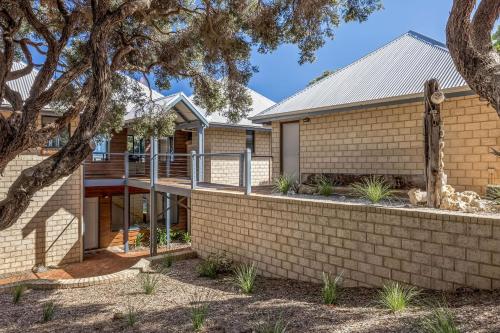a house with a retaining wall and a fence at Yallingup Bliss in Yallingup