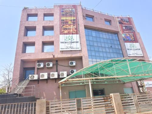 a building with a sign on the side of it at The Sky Comfort, Ahmedabad in Ahmedabad
