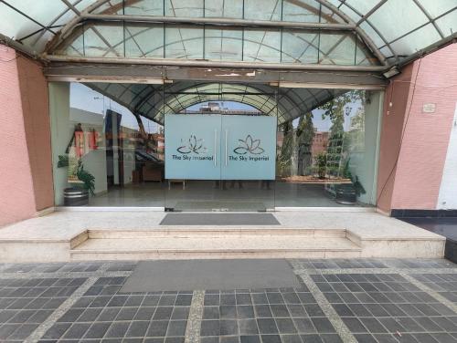 a glass building with a door in the middle at The Sky Comfort, Ahmedabad in Ahmedabad