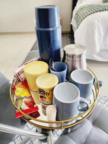 a tray with cups and other items on a table at Eastern Road Executive Suites in Harare