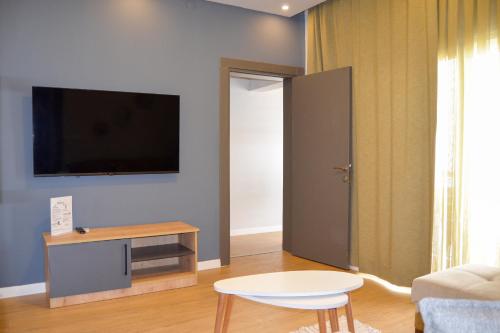 a living room with a flat screen tv on a wall at Loca Centre Suites in Bodrum City