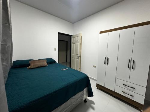a white bedroom with a bed and a closet at Premium in Comayagua