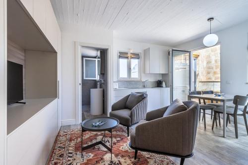 a living room with a couch and chairs and a table at Old Theatre Suites - Maddalena in Valletta