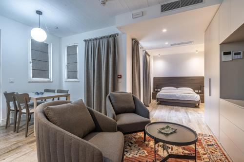 a hotel room with a bedroom and a bed at Old Theatre Suites - Maddalena in Valletta