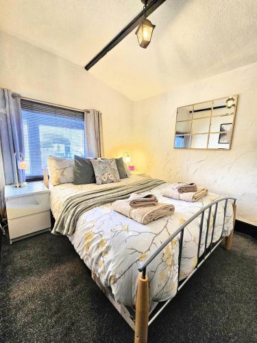 a bedroom with two beds and a window at Leaf Tree Cottage, close to Coast, Lakes and Fells in Workington