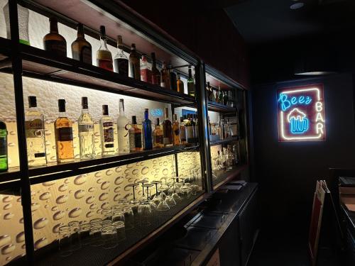 a bar with a lot of bottles of alcohol at Hotel KIMAYA Slipi Jakarta By HARRIS in Jakarta