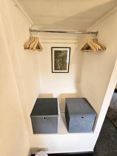 a stairway with two drawers and a box in a room at Leaf Tree Cottage, close to Coast, Lakes and Fells in Workington