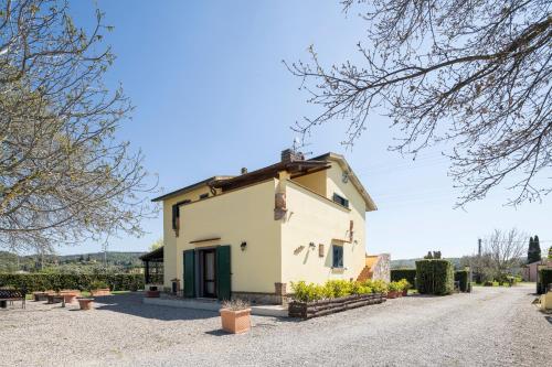 a large white building on a gravel road at Casale Fattoria Benaris With Private Pool - Marsiliana in Marsiliana