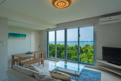 a living room with a view of the ocean at "オーシャンビュー ヴィラ南十字星 " Two-Bedroom Villa in Ishigaki Island