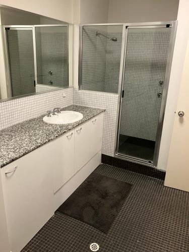 a bathroom with a sink and a shower at Great Place in Perth CBD - 2 bedrooms - parking included in Perth