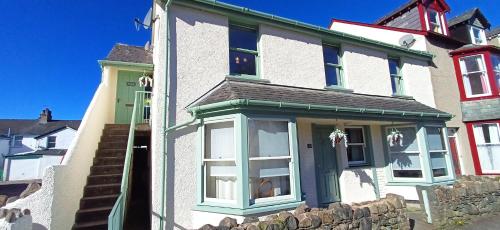 a white house with a green door at Aura in Keswick