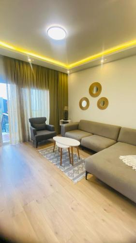 a living room with a couch and a table at Loca Centre Suites in Bodrum City