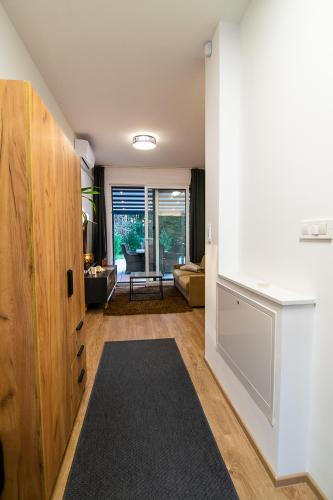 a living room with a large wooden cabinet and a black rug at Apartments Villa Prod in Ljubljana