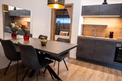 a kitchen with a table and chairs and a sink at Apartments Villa Prod in Ljubljana