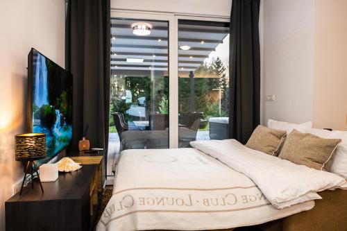 a bedroom with a bed and a sliding glass door at Apartments Villa Prod in Ljubljana