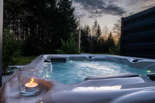 a candle sitting in a jacuzzi tub with a candle at Apartments Villa Prod in Ljubljana