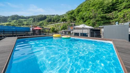 a large swimming pool on the roof of a house at Gapyeong poin PoolVilla pension in Gapyeong