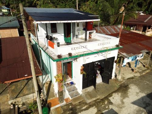 an overhead view of a white building with a blue roof at SEE BUKIT LAWANG Homestay & Tours in Bukit Lawang
