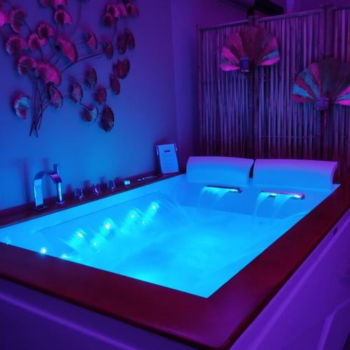 a room with a tub with purple lights in it at Siramà Suite Deluxe in Oria