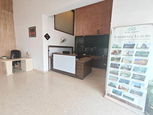 a room with a display case and a white wall at The Sky Comfort, Ahmedabad in Ahmedabad