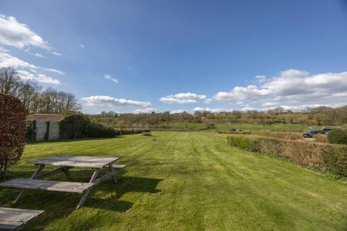 a picnic table in the middle of a field at Fletcher Hotel Restaurant Bon Repos in Noorbeek