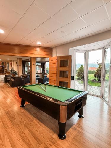 a pool table in the middle of a living room at Puigcerda Park Hotel in Puigcerdà