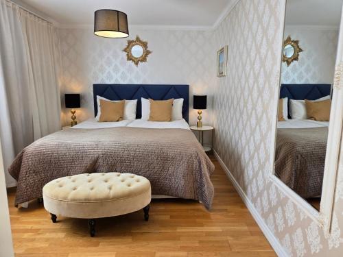 a bedroom with a large bed with a large mirror at Vänerport Lakefront Hotell in Mariestad
