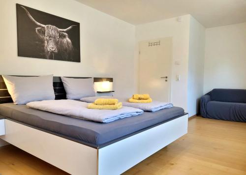 a bed with two yellow pillows on top of it at Wohnraum by Steidle in Buxheim