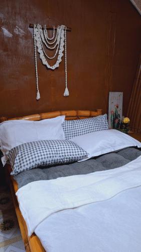 two beds in a bedroom with white pillows at Bahay Bakasyunan in Lubao near Pradera Verde in Lubao