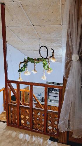 a chandelier hanging from a ceiling in a room at Bahay Bakasyunan in Lubao near Pradera Verde in Lubao