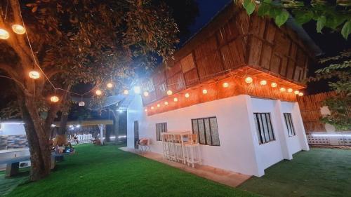 a small house with lights on the side of it at Bahay Bakasyunan in Lubao near Pradera Verde in Lubao