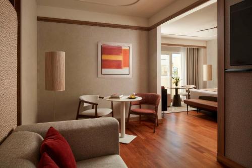 a living room with a couch and a table at NH Collection Marbella in Marbella