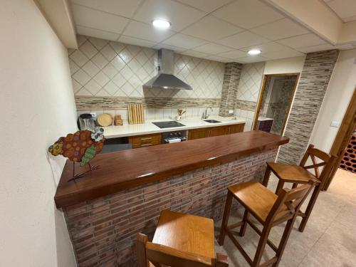 a kitchen with a counter and some chairs in a room at Chalet los Jardines in Polanco