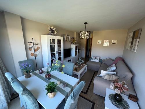 a living room with a couch and a table and chairs at Chalet los Jardines in Polanco