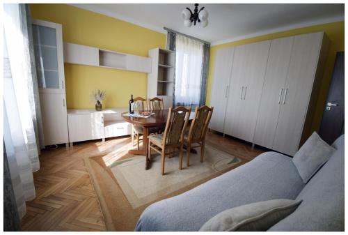 a living room with a table and a dining room at Color 24 - Złoty Punkt in Stalowa Wola