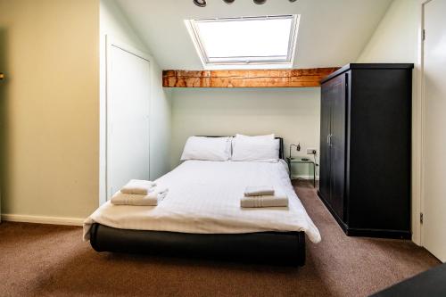 a bedroom with a large bed with a skylight at The Lodge Harrogate in Harrogate