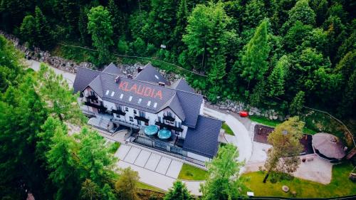 an overhead view of a large house in the forest at Hotel Klaudia in Juszczyn