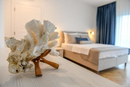 a sculpture of a seashell on a table in a room at Vila sa bazenom Vrnjačka Idila in Vrnjačka Banja