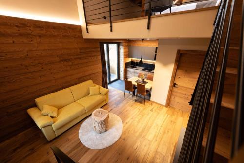 a living room with a couch and a table at Ca' Leonardi II - Ledro in Tiarno di Sotto
